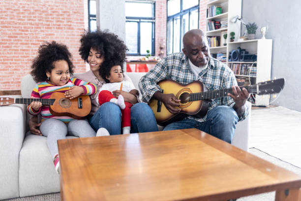 istock Family playing guitar at home 1127314778