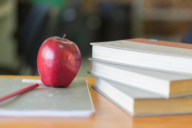 istock School teacher's desk with stack of books and apple, Educational concept. 1127314867