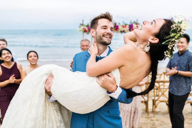 istock Cheerful newlyweds at beach wedding ceremony 1127316056