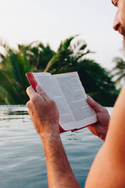 istock Man reading a book in the swimming pool 1127316485