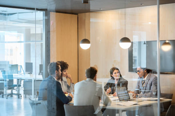 istock Multi-ethnic colleagues planning in board room 1127316707