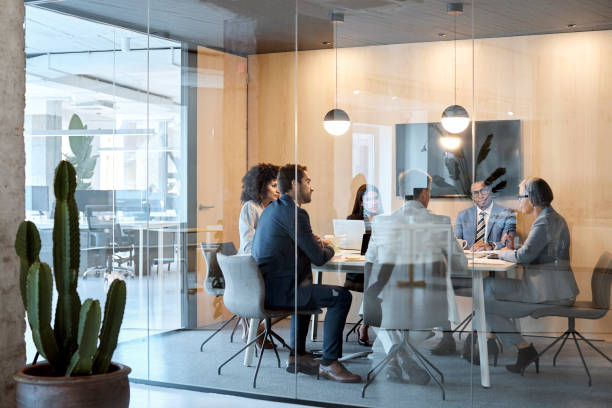 istock Full length of colleagues discussing in board room 1127316802