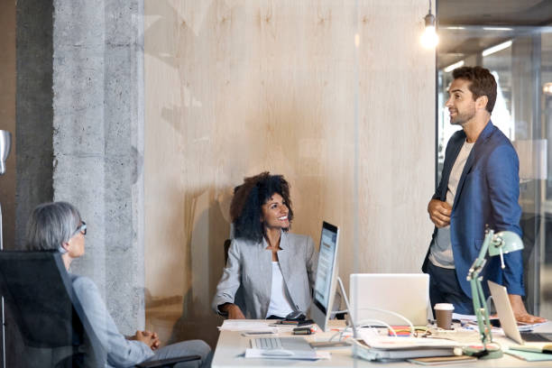 istock Happy colleagues discussing in board room 1127317463