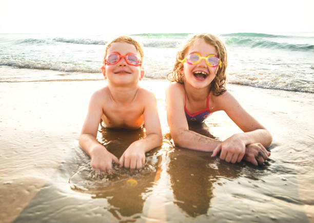 istock Little brother and sister having fun on the beach 1127318457
