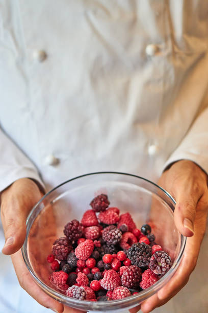 Fruit frozen wild berries in a bowl amerikanische heidelbeere stock pictures, royalty-free photos & images