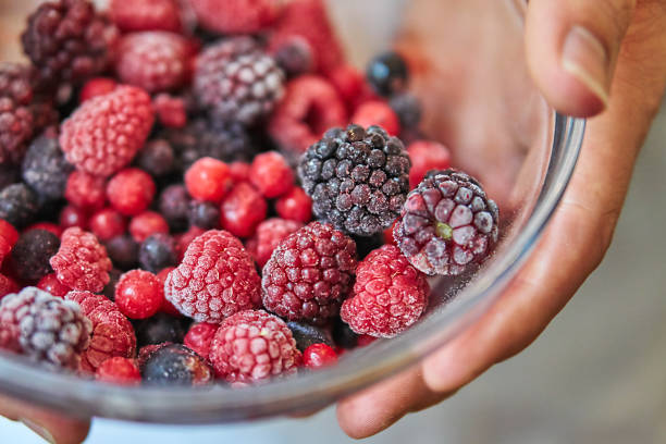 Fruit frozen wild berries in a bowl amerikanische heidelbeere stock pictures, royalty-free photos & images