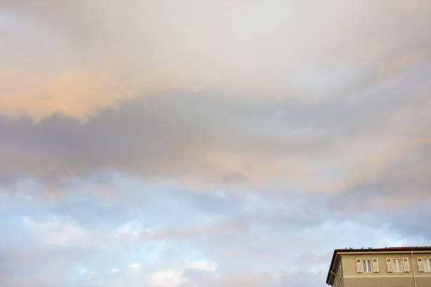 Stormy clouds in the sky, over the roofs of some homes - photograph