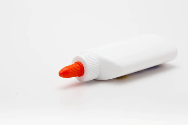 istock Glue Leak from White Glue Bottle with Spreader Cap on white 1127320415