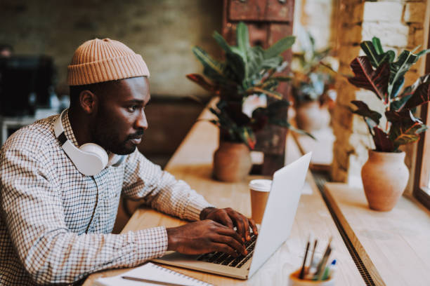 istock Busy student typing while sitting with his laptop in cafe 1127320782