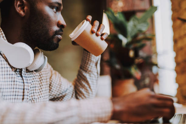 istock Close up of serious man holding paper cup 1127320785
