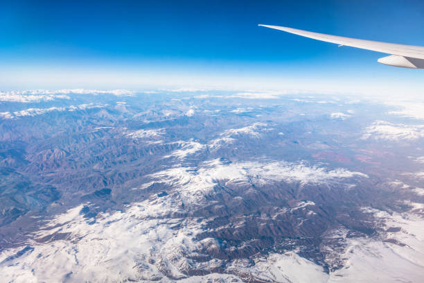 istock Wing of an airplane flying above the clouds with blue sky. 1127321588