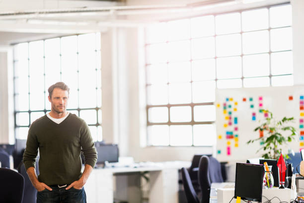 istock Confident businessman with hands in pockets 1127322258