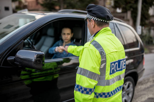 istock Police office giving a speeding ticket to a lady driver 1127322576