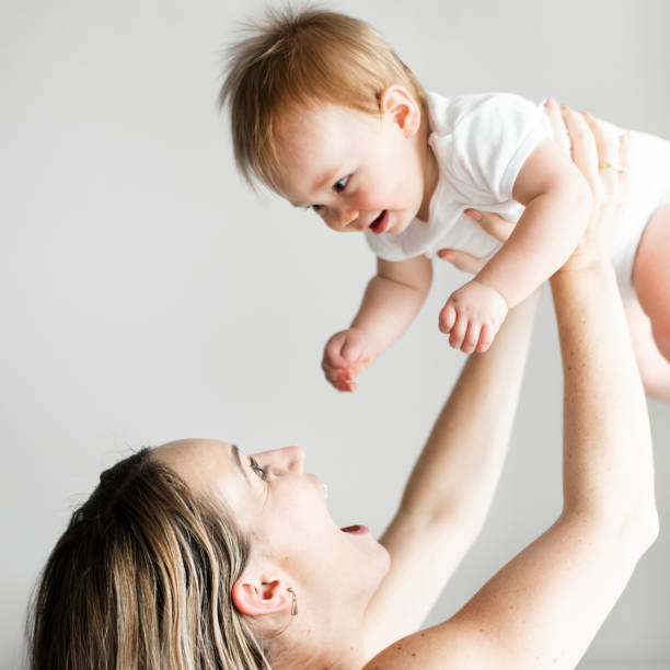 istock Mom playing with her baby 1127323144