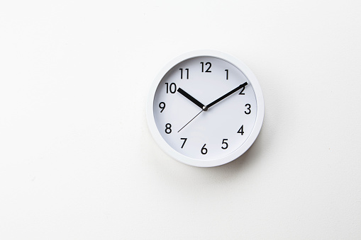 White wall clock on white background