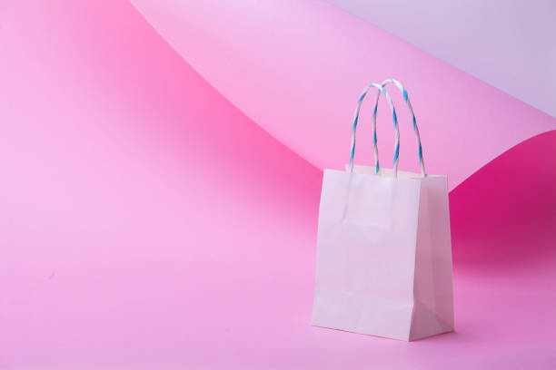 istock White shopping bag on abstract pink background for design 1127326554