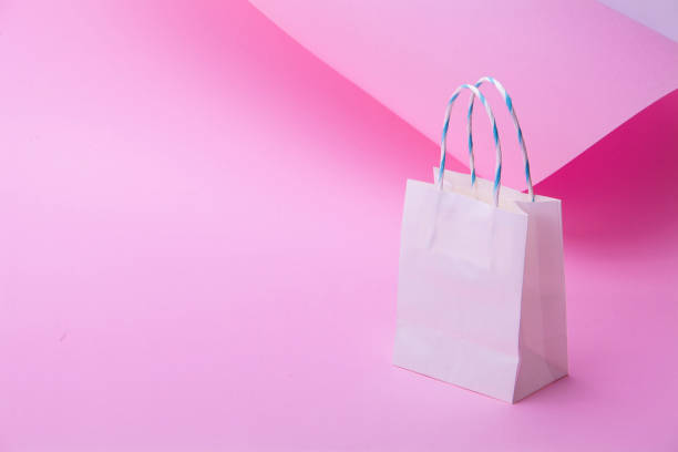istock White shopping bag on abstract pink background for design 1127326559
