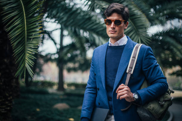 istock Stylish businessman walking in the park 1127327512