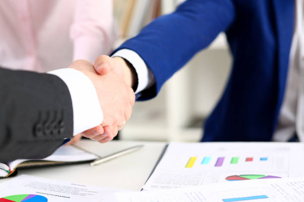istock Man in suit shake hand as hello in office closeup 1127330168