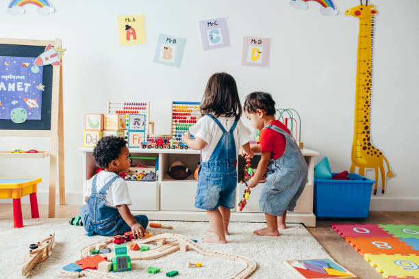 Young children enjoying in the playroom Young children enjoying in the playroom playroom stock pictures, royalty-free photos & images