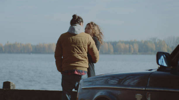 istock Young couple cuddling by the lake 1127330602