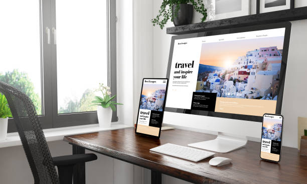 istock black and white desktop with three devices showing  travel blog 1127330622