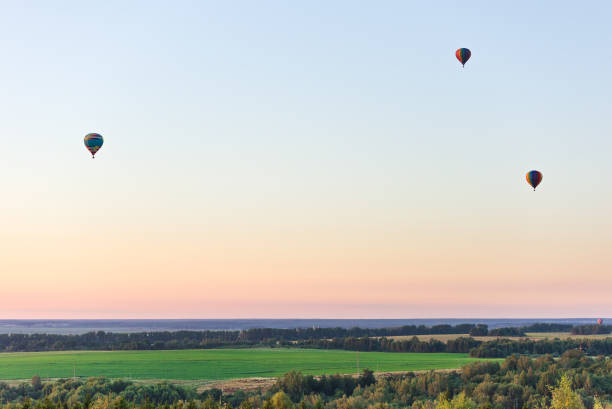 istock Flying in a balloon. Three objects in the air against a cloudless sky 1127330742