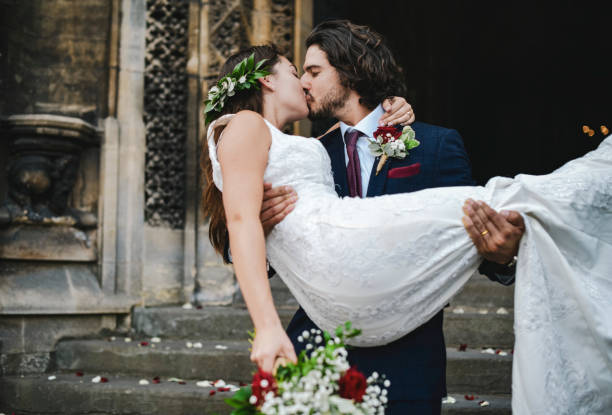 istock Groom lifting up his beautiful bride 1127330838