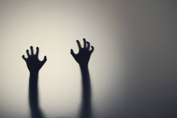 dark silhouette of woman hands behind glass door. concept of depression, fear, panic attacks - frosted glass glass textured bathroom imagens e fotografias de stock