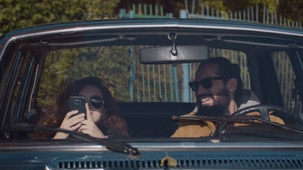 istock Couple having fun in a retro car. Forest trip. Close up 1127331428