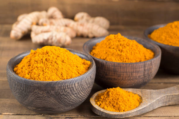 istock Turmeric powder and fresh turmeric on wooden background 1127332091