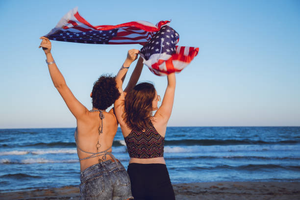 istock Waving USA flag at the beach 1127332262