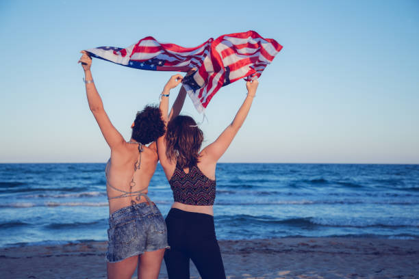 istock Waving USA flag at the beach 1127332472