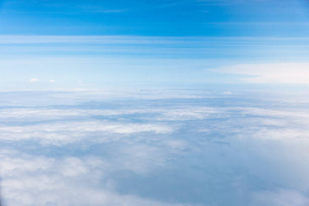 istock Wing of an airplane flying above the clouds with blue sky. 1127332824