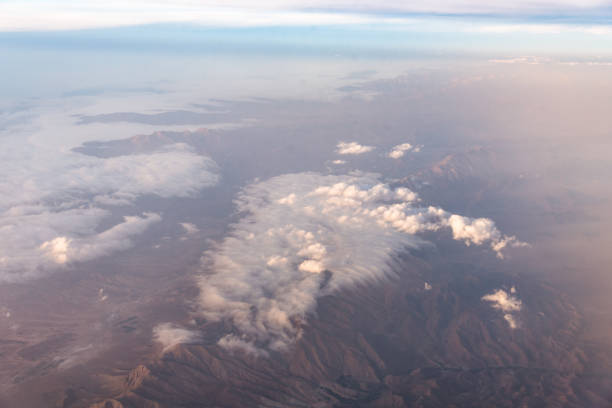 istock Wing of an airplane flying above the clouds with blue sky. 1127332830