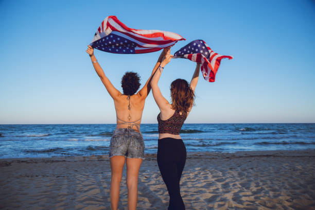 istock Waving USA flag at the beach 1127333542