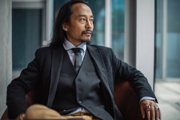 istock Handsome elegant mature gentleman sitting in chair 1127334223