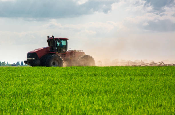 istock Farmer in tractor preparing land with seedbed cultivator 1127334229