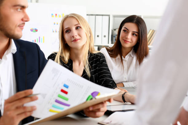 istock Group of people hold silver pen ready to make 1127336675
