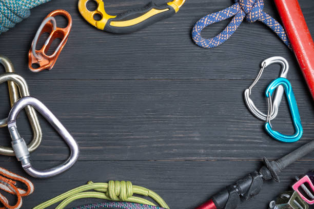 istock climbing equipment on a wooden black background 1127337946