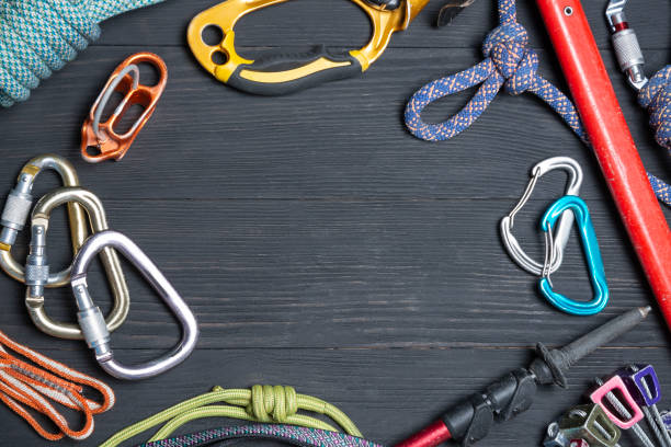 istock climbing equipment on a wooden black background 1127337967
