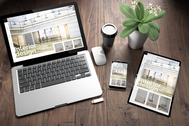 istock three devices on wooden desk top view interior design website 1127338440