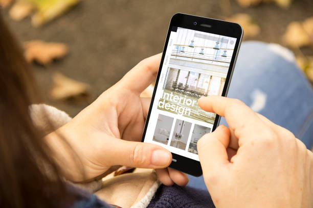 istock woman with interior design website design phone in the park 1127338465