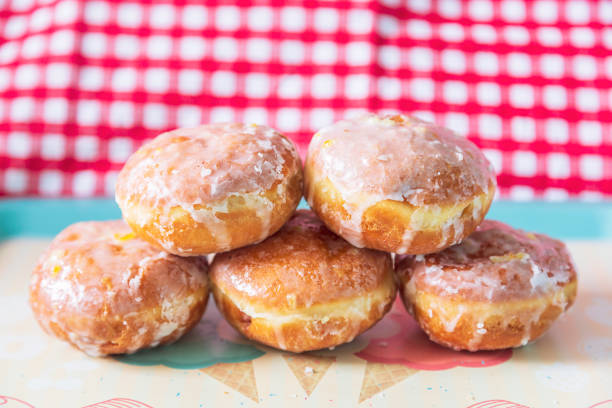 Polish donuts Five donuts without a hole covered with icing, prepared on Fat Thursday Paczki stock pictures, royalty-free photos & images