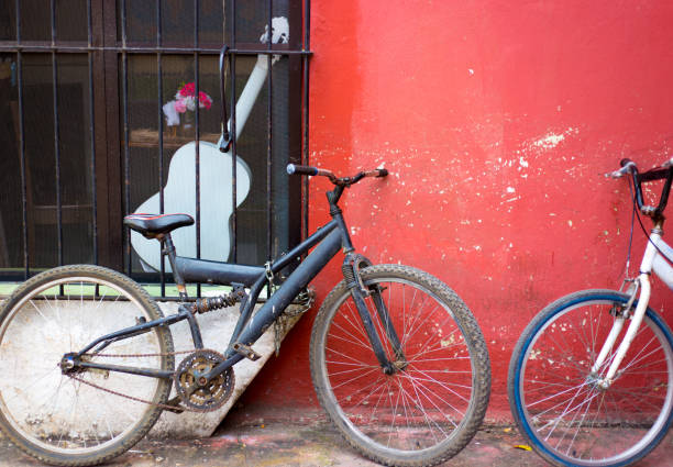 istock Mexico: Two Old Bikes Against Vibrant Pink-Red Wall 1127341695