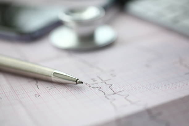 istock Medical stethoscope head and silver pen lying on 1127342417