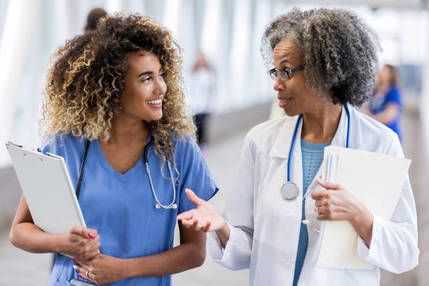 istock Attentive mixed race nurse talking with doctor 1127343830
