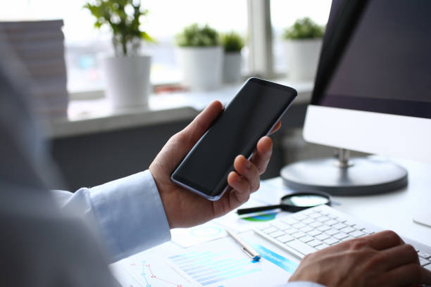 istock Businessman hipster holds telephone background 1127346344
