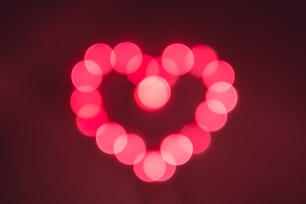 istock red bokeh lights background. heart shaped lights. 1127346443
