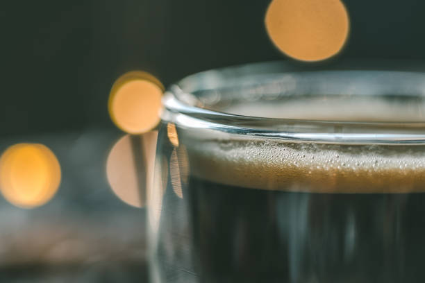 espresso in a glass cup with bokeh lights on background and copy-space for text
